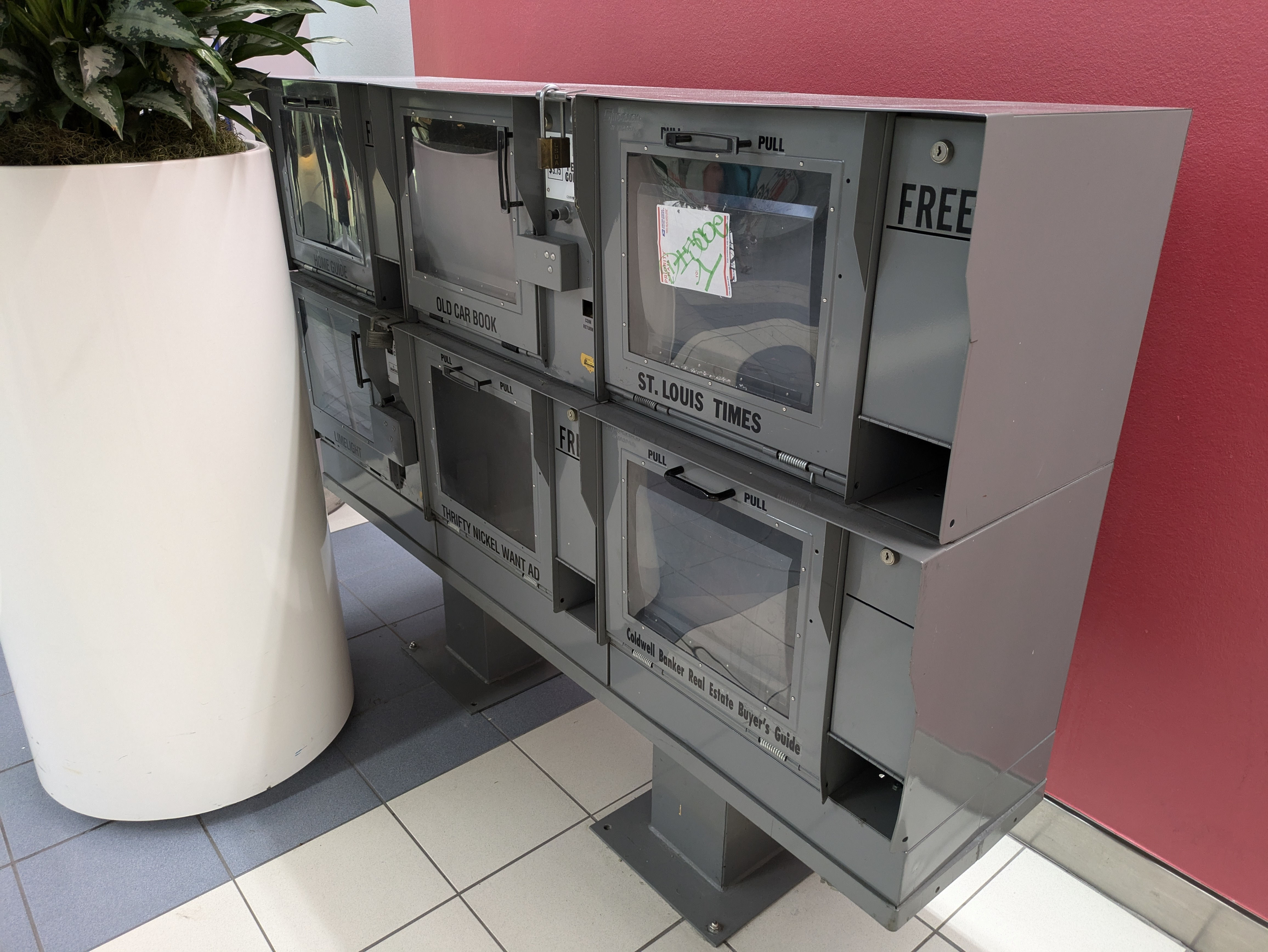 Six empty periodical vending machines, for "Home Guide", "Limelight", "Old Car Book", "Thrifty Nickel Want Ad", "Caldwell Banker Real Estate Buyer's Guide", and "St. Louis Times"